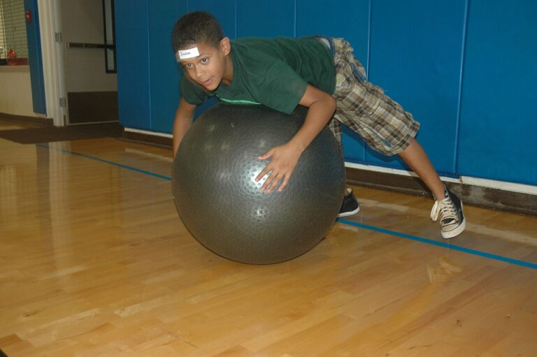 HELEMANO MILITARY RESERVATION, Hawaii - Jordan Cleveland, 12, takes to the air while on an exercise ball during an Excel, Develop, Grow and