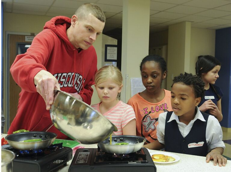 U.S. Air Force Tech. Sgt. Matthew Fons, an aircraft mechanic with the 62nd Aircraft Maintenance Squadron, pours battered eggs into a pan, du